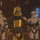 Commander Pyre talking to Captain Phasma, they both have metallic trooper outfits.